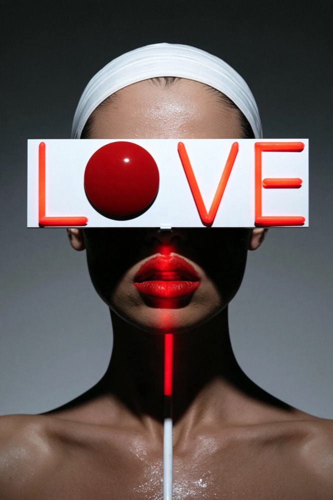 A face with red lips and a white headband, eyes covered by a white LOVE sign with a red ball for the O