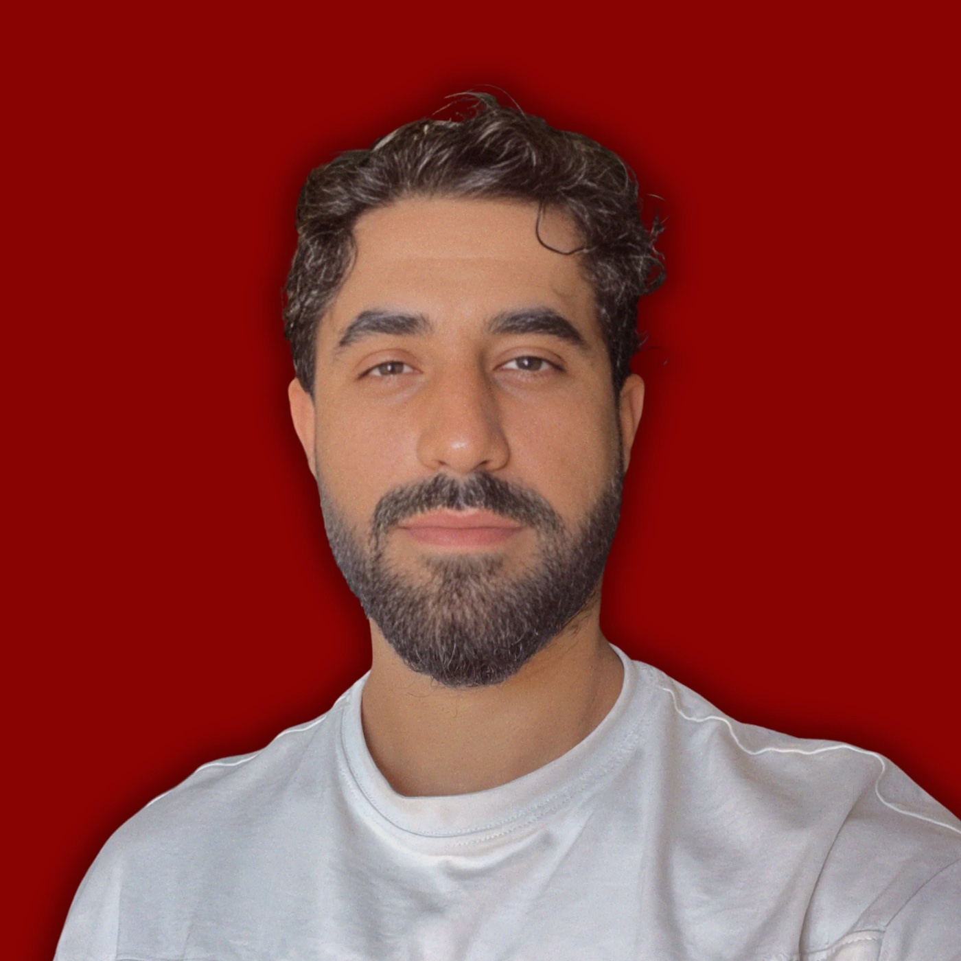 SNX, portrait in a white T-shirt against a red background